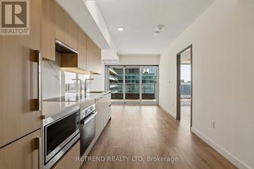 Toronto (Waterfront Communities) condo for rent - A modern kitchen with wooden cabinets and stainless steel appliances.