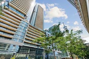 Toronto (Waterfront Communities) condo for rent - A tall building with the words "Retrend Realty" on the front.