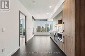 Toronto (Waterfront Communities) condo for rent - A modern kitchen with wooden cabinets and stainless steel appliances.