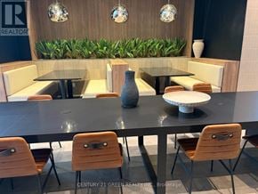 Brampton (Bram East) condo for rent - A modern dining area with a glass table and chairs.