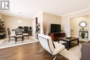 Toronto (Beechborough-Greenbrook) multi-family for rent - A living room with a white chair in the foreground.