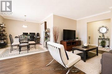 Toronto (Beechborough-Greenbrook) multi-family for rent - A living room with a white chair in the foreground.