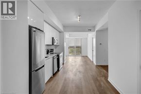 Brantford condo for rent - A modern kitchen with stainless steel appliances and wooden flooring.