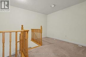 Toronto (L'amoreaux) townhouse for rent - A room with a carpeted floor and a wooden railing.