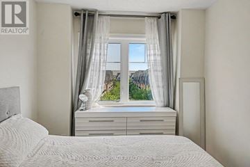 Toronto (L'amoreaux) townhouse for rent - A bedroom with a large bed and a window with curtains.