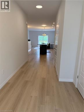 Simcoe townhouse for rent - A long hallway with wood floors and white walls.