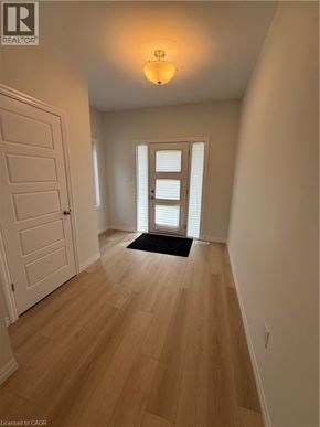 Simcoe townhouse for rent - A hallway with a door and a window.