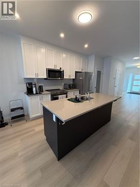 Simcoe townhouse for rent - A modern kitchen with a large island in the middle.