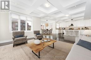 King (King City) apartment for rent - A spacious living room with a wooden coffee table and patterned armchairs.