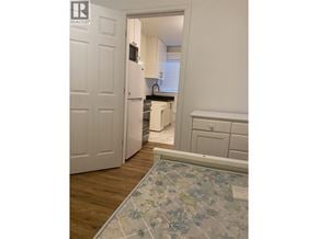 Vancouver apartment for rent - A kitchen area with a refrigerator, microwave, and a sink.