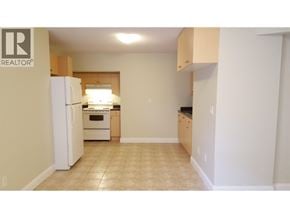 Coquitlam apartment for rent - A kitchen with a white refrigerator and a white oven.