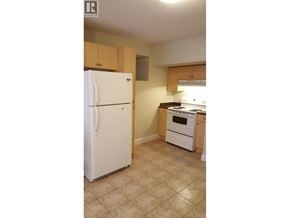 Coquitlam apartment for rent - A kitchen with a white refrigerator and a white oven.