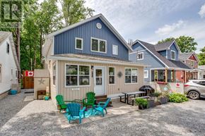 Fort Erie (Crystal Beach) duplex for rent - A blue house with a white porch and a red house in the background.