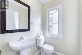 Burlington (Alton) townhouse for rent - A white sink and toilet in a bathroom with a mirror above it.