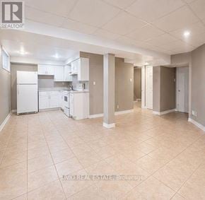 Toronto (Woburn) apartment for rent - A spacious kitchen and living room with beige tiled flooring and white appliances.