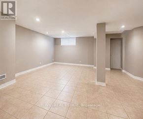 Toronto (Woburn) apartment for rent - A spacious empty room with beige tiled flooring and white walls.