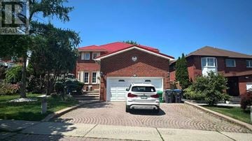 Mississauga (Hurontario) apartment for rent - A car is parked in front of a house with a red roof.