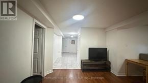 Mississauga (Hurontario) apartment for rent - A living room with a television and a chair.