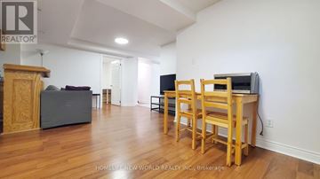 Mississauga (Hurontario) apartment for rent - A living room with a television and a chair.