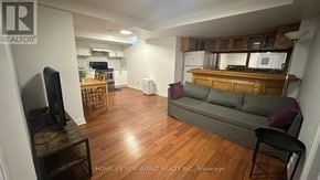 Mississauga (Hurontario) apartment for rent - A living room with a grey couch and a television.