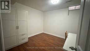 Mississauga (Hurontario) apartment for rent - A room with a wooden floor and white walls, with a white cabinet and a white door.