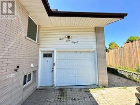 Kitchener apartment for rent - A white garage door is closed and there is a sign on the wall above it.