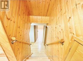 Kitchener apartment for rent - A wooden staircase with a metal handrail.