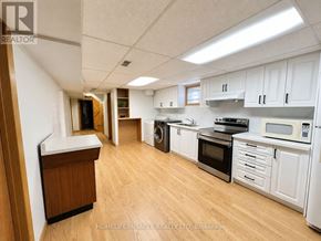 Kitchener apartment for rent - A kitchen with white cabinets and wooden floors.