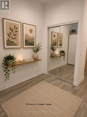 Toronto (Regent Park) condo for rent - A room with a rug, a wall-mounted shelf with plants, and two framed pictures.