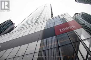 Toronto (Waterfront Communities) condo for rent - A tall building with the words "TRIODEL" and "BUILT FOR LIFE" on it.