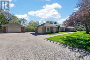 New Tecumseth apartment for rent - A large, paved driveway leads to a house with a garage.