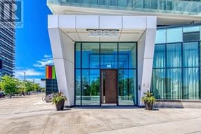 Mississauga (City Centre) condo for rent - The front of a building with a glass door and windows.