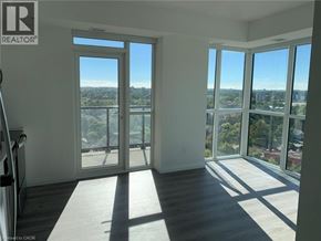 Kitchener condo for rent - A room with a view of the city through large windows.