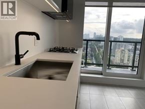 Vancouver apartment for rent - A modern kitchen with a large window overlooking the city.