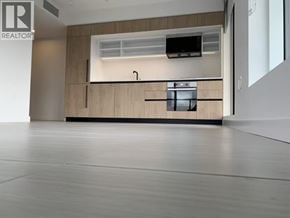 Vancouver apartment for rent - A modern kitchen with a wooden cabinet and a stainless steel sink.