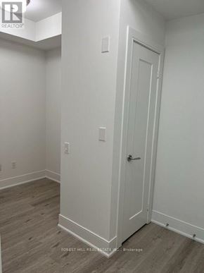 Toronto (Forest Hill South) house for rent - A white door is on the right side of a room with wood flooring.