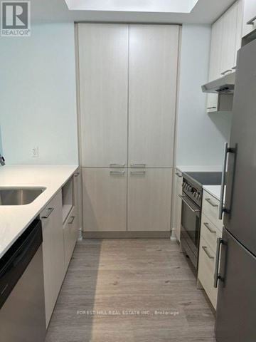 Toronto (Forest Hill South) house for rent - A kitchen with white cabinets and a refrigerator.