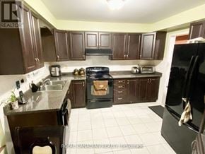 Markham (Middlefield) apartment for rent - A kitchen with brown cabinets and a black stove top oven.