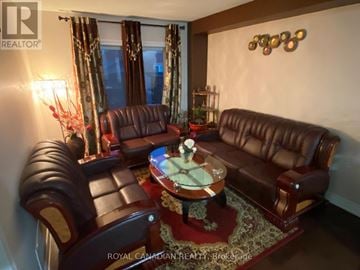 Markham (Middlefield) apartment for rent - A brown leather couch and chair set in a living room.