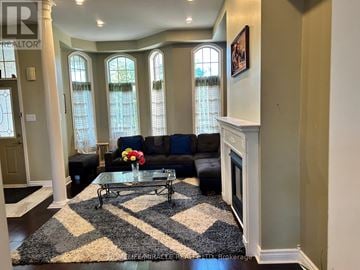 Markham (Cornell) townhouse for rent - A living room with a black and white rug and a fireplace.