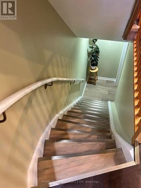 Markham (Cornell) townhouse for rent - A staircase with wooden steps and a metal handrail.