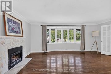 Ottawa apartment for rent - A living room with a fireplace and a painting on the wall.