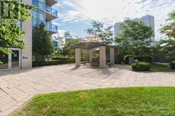 Mississauga (City Centre) condo for rent - A courtyard with a pavilion and a tree in the middle.