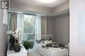 Mississauga (City Centre) condo for rent - A bedroom with a bed, nightstand, and window with curtains.