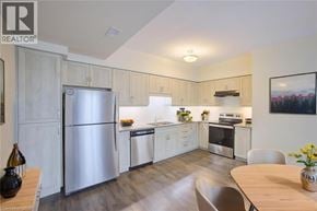 Kitchener townhouse for rent - A modern kitchen with a refrigerator, oven, and sink.