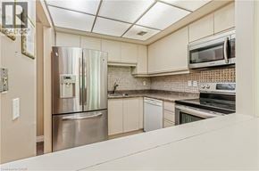 Richmond Hill apartment for rent - A kitchen with a stainless steel refrigerator and white cabinets.