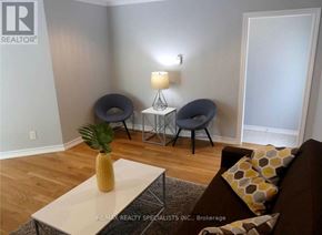 Barrie (Edgehill Drive) duplex for rent - A living room with a couch, chair, and lamp.
