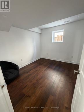 Halton Hills (Georgetown) apartment for rent - A room with wooden floors and a small window.