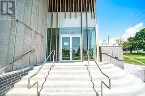 Pickering (Bay Ridges) condo for rent - A building with a glass door and a sign that says "1910 Sunny Beach".