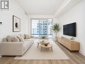 Pickering (Bay Ridges) condo for rent - A living room with a couch, a coffee table, and a flat screen TV.